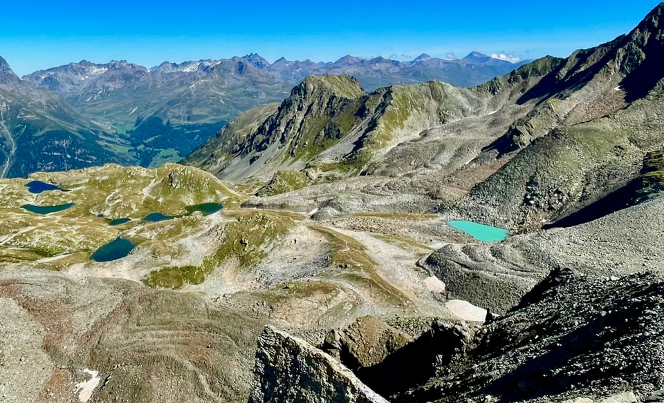 Hochgebirgslandschaft mit Seen und Tälern.