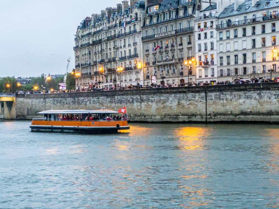 Paris 2024: Das Schiff mit den schweizer Sportlerinnen und Sportler fährt auf der Seine.