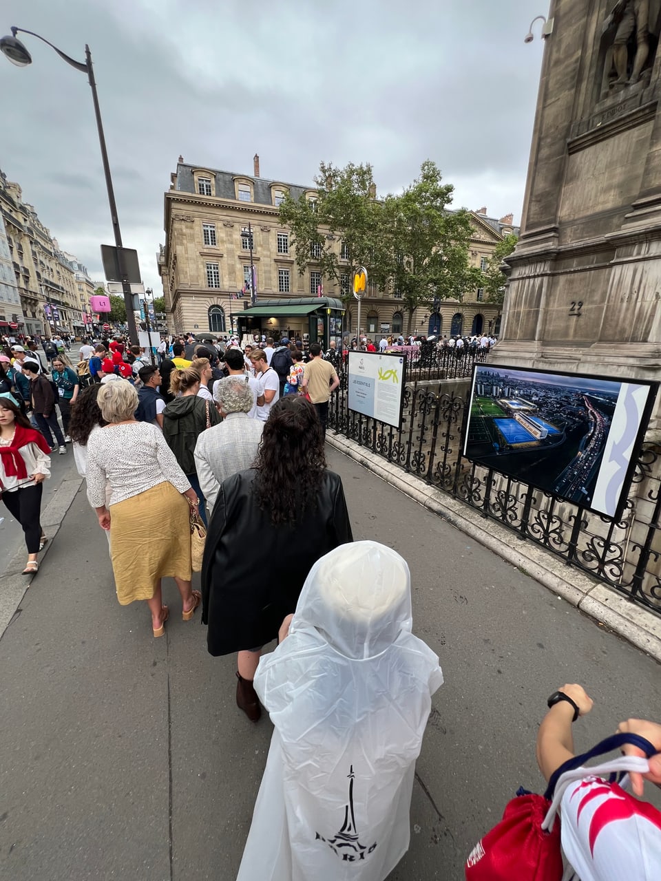 Paris2024: Menschen stehen in Kolonnen.