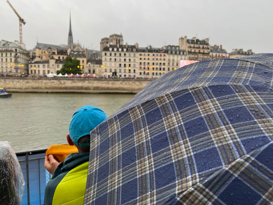 Paris 2024: Regenschirm verhindert die Sicht auf den Bildschirm.